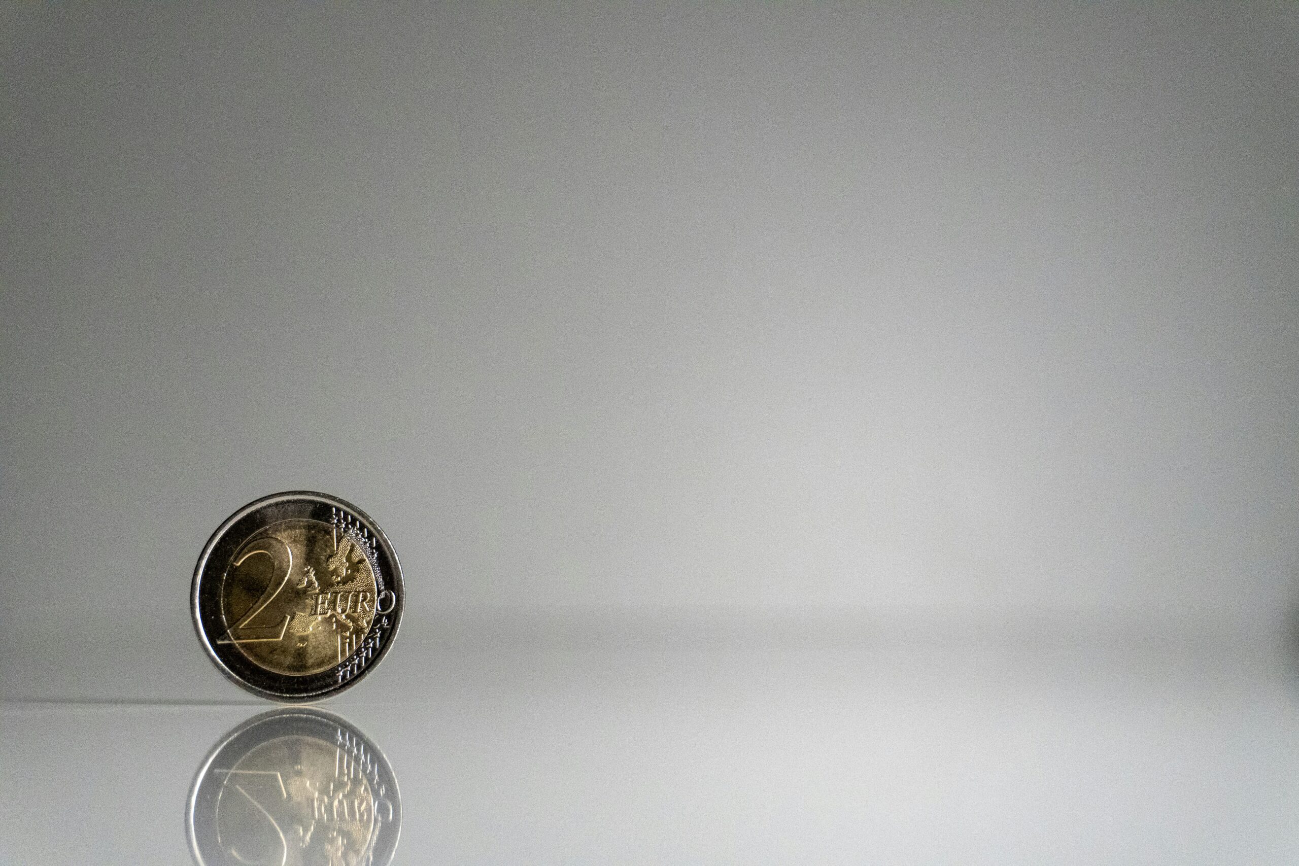 How to Manage Your Money So You Never Go Broke 5 a close up of a coin on a reflective surface